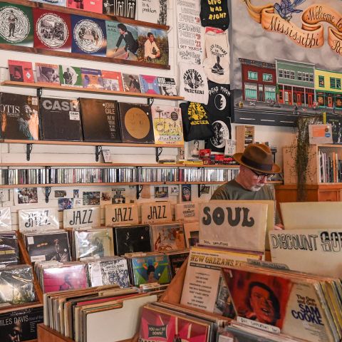 A man browses bins of records in a vintage record store