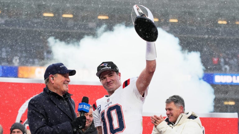 New England Patriots quarterback Drake Maye celebrates with the trophy after the AFC Championship NFL football game between the Denver Broncos and the New England Patriots, Sunday, Jan. 25, 2026, in Denver.