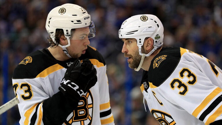 Charlie McAvoy #73 and Zdeno Chara #33 of the Boston Bruins talk during Game Two of the Eastern Conference Second Round against the Tampa Bay Lightning during the 2018 NHL Stanley Cup Playoffs at Amalie Arena on April 30, 2018 in Tampa, Florida.