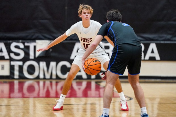 Yorkville's Graham Martinson (10) defends the top of the key against St. Charles North's Braden Harms (5) during a Ernie Kivisto Hoops Fest game in Aurora on Saturday, Jan. 31, 2026. (Sean King / For The Beacon-News)