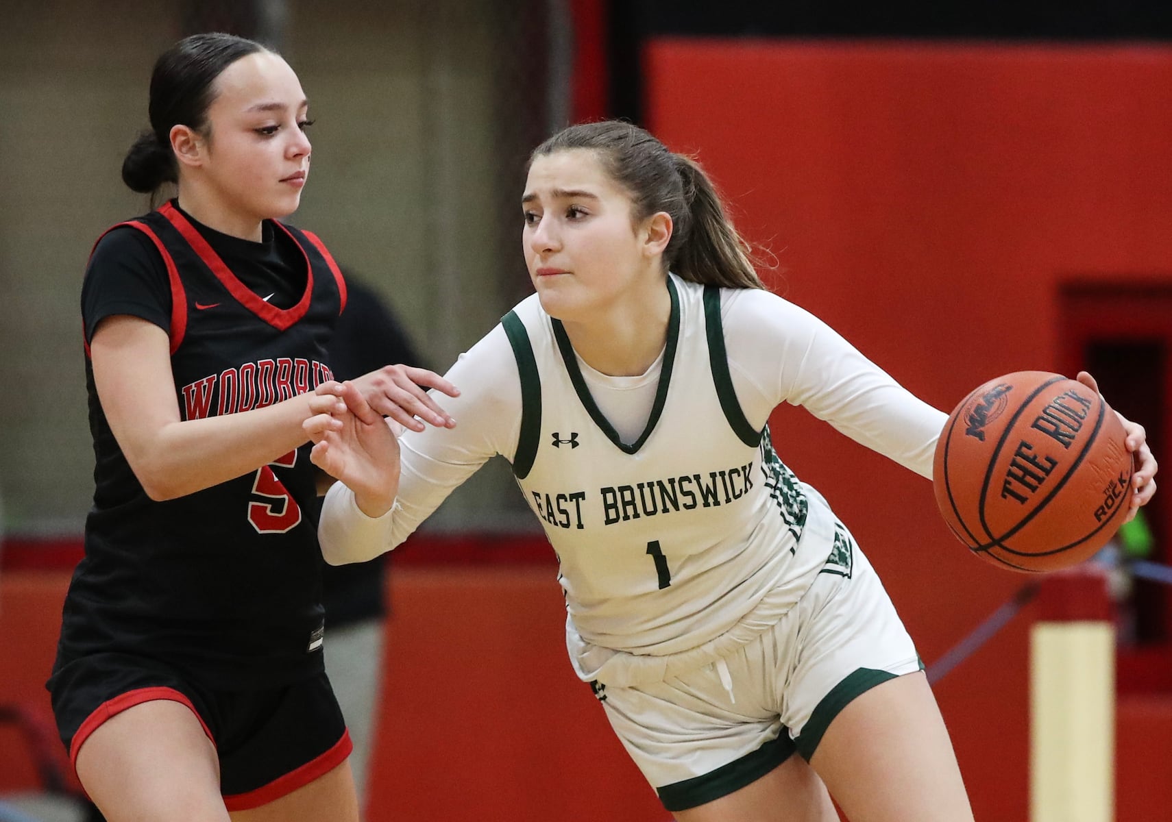 Ava Catanho (1) of East Brunswick drives against Layla Mercado (5) of Woodbridge during the girls basketball game between Woodbridge and East Brunswick at Woodbridge High School in Woodbridge, NJ on 2/2/26.