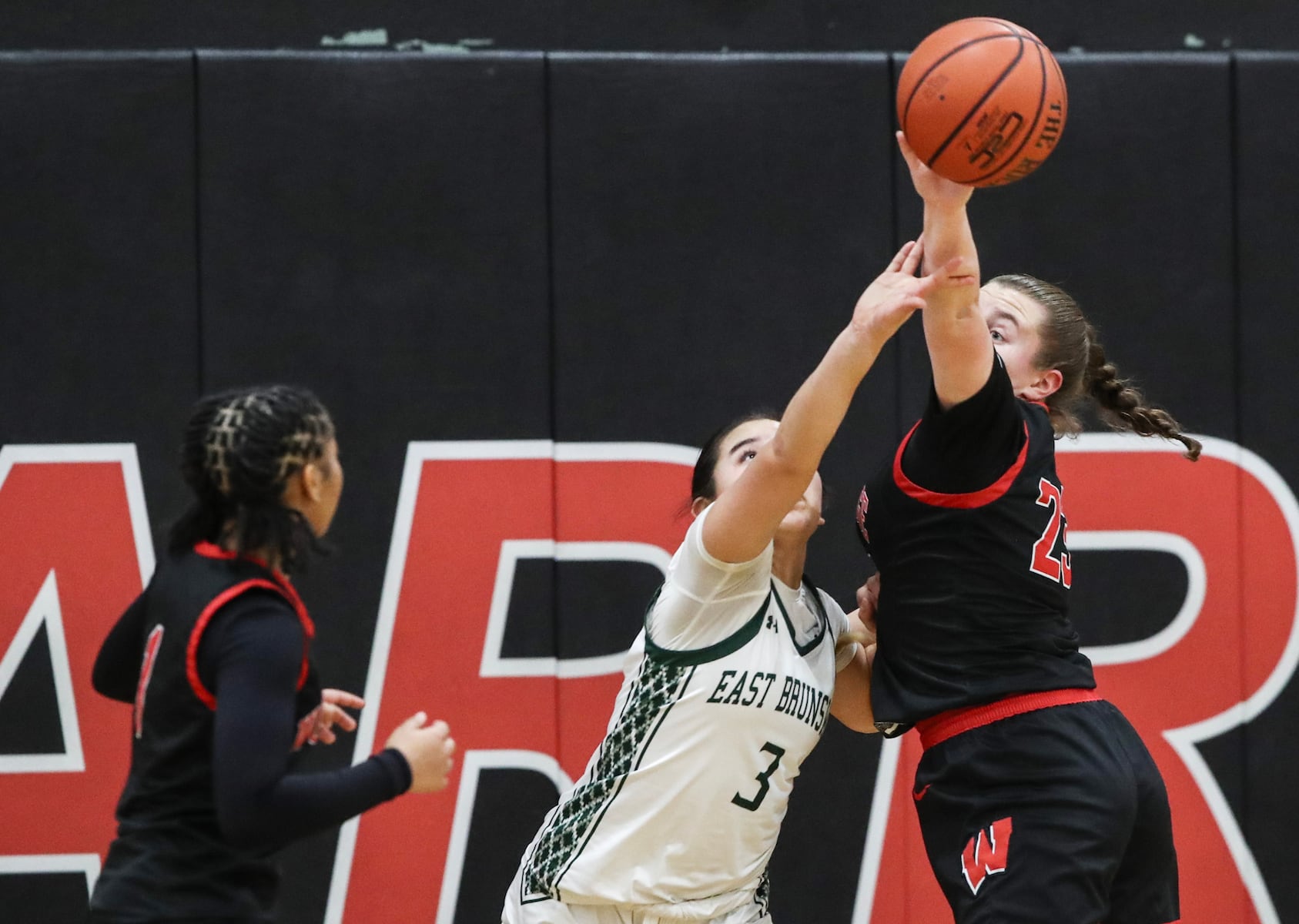 Bobbi Jo Timinski (23) of Woodbridge tries to block the ball from Sophia Tannura (3) of East Brunswick during the girls basketball game between Woodbridge and East Brunswick at Woodbridge High School in Woodbridge, NJ on 2/2/26.