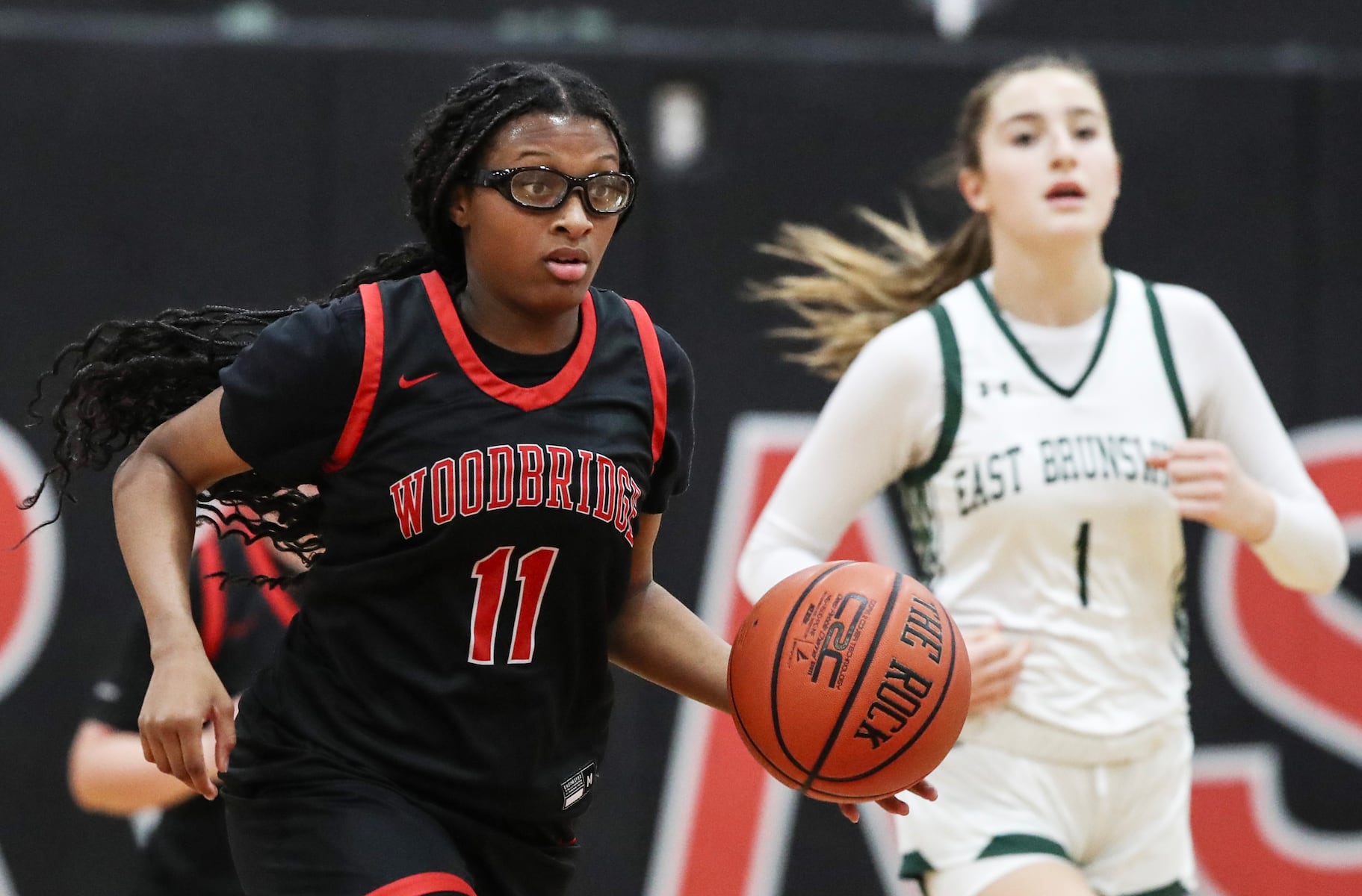 Angel Smith (11) of Woodbridge dribbles up the floor during the girls basketball game between Woodbridge and East Brunswick at Woodbridge High School in Woodbridge, NJ on 2/2/26.