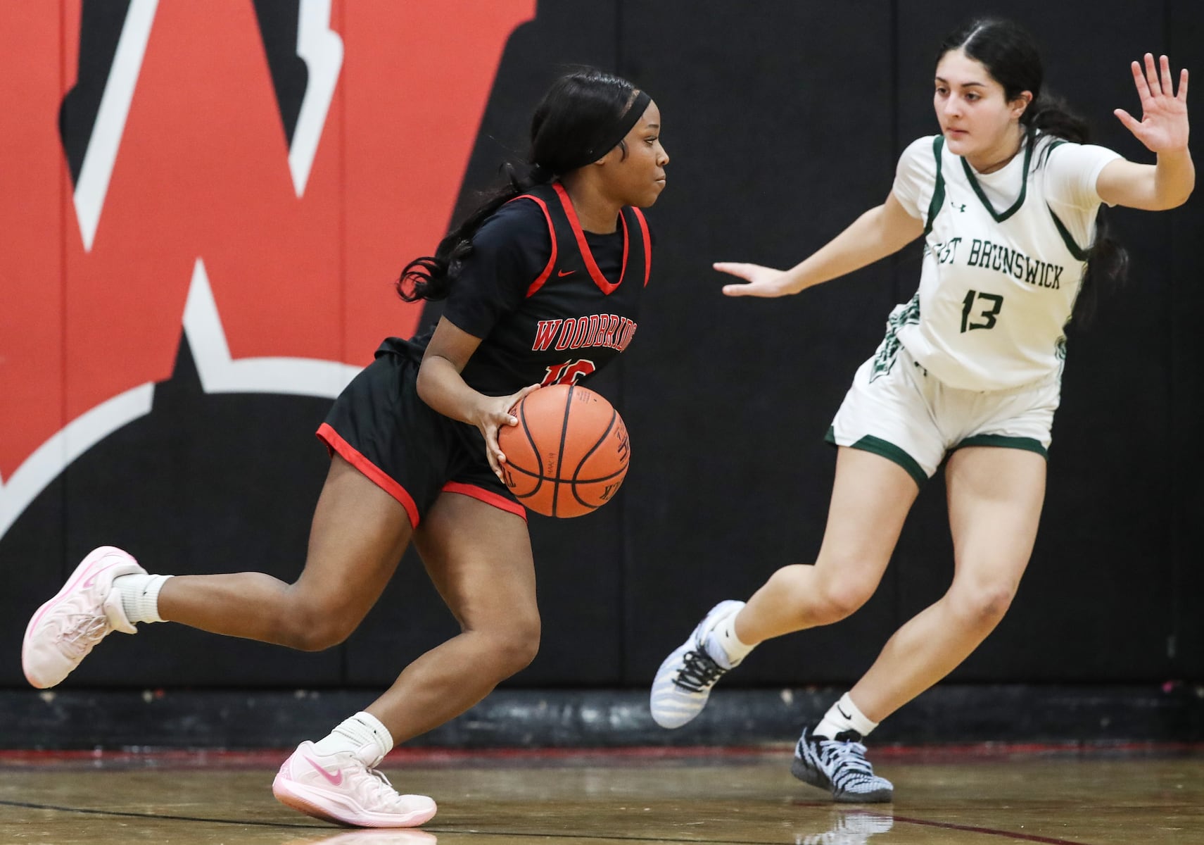 Laila Stanford (10) of Woodbridge dribles against Mia Figueroa (13) of East Brunswick during the girls basketball game between Woodbridge and East Brunswick at Woodbridge High School in Woodbridge, NJ on 2/2/26.
