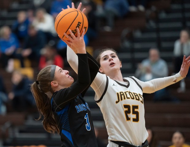 Burlington Central's Julia Scheuer (3) shoots past Jacobs' Olivia Schuster (25) during their game at Jacobs High School in Algonquin on Wednesday, February 11, 2026. (Ryan Rayburn/for the Aurora Beacon News)