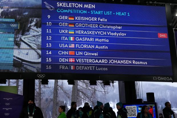 A scoreboard, that indicates that Ukrainian skeleton athlete Vladyslav Heraskevych did not start, is seen at the 2026 Winter Olympics