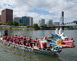 dragon boat with rowers in Wilamette River