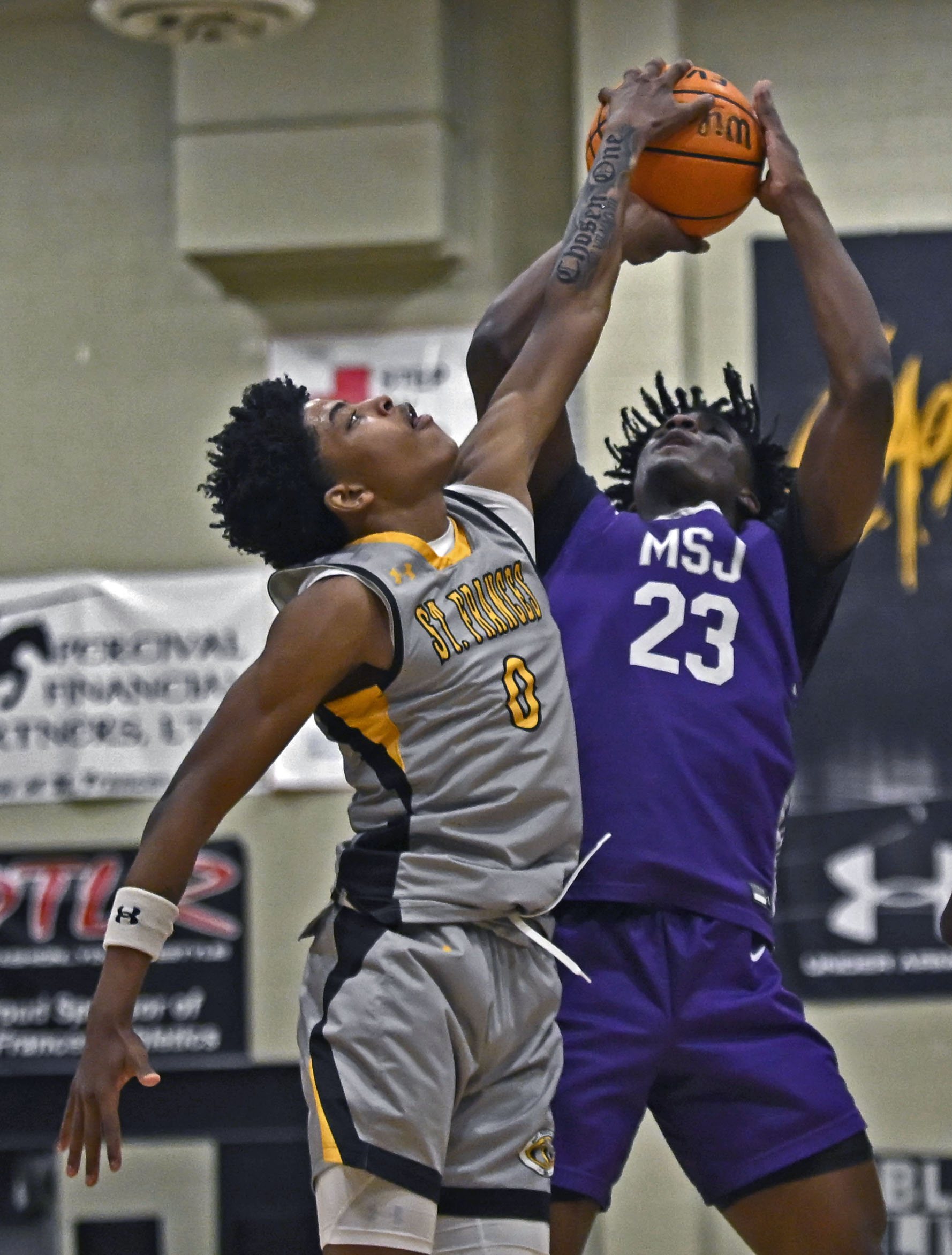 St. Francesâ Terence Jones, left, blocks a shot by Mount...