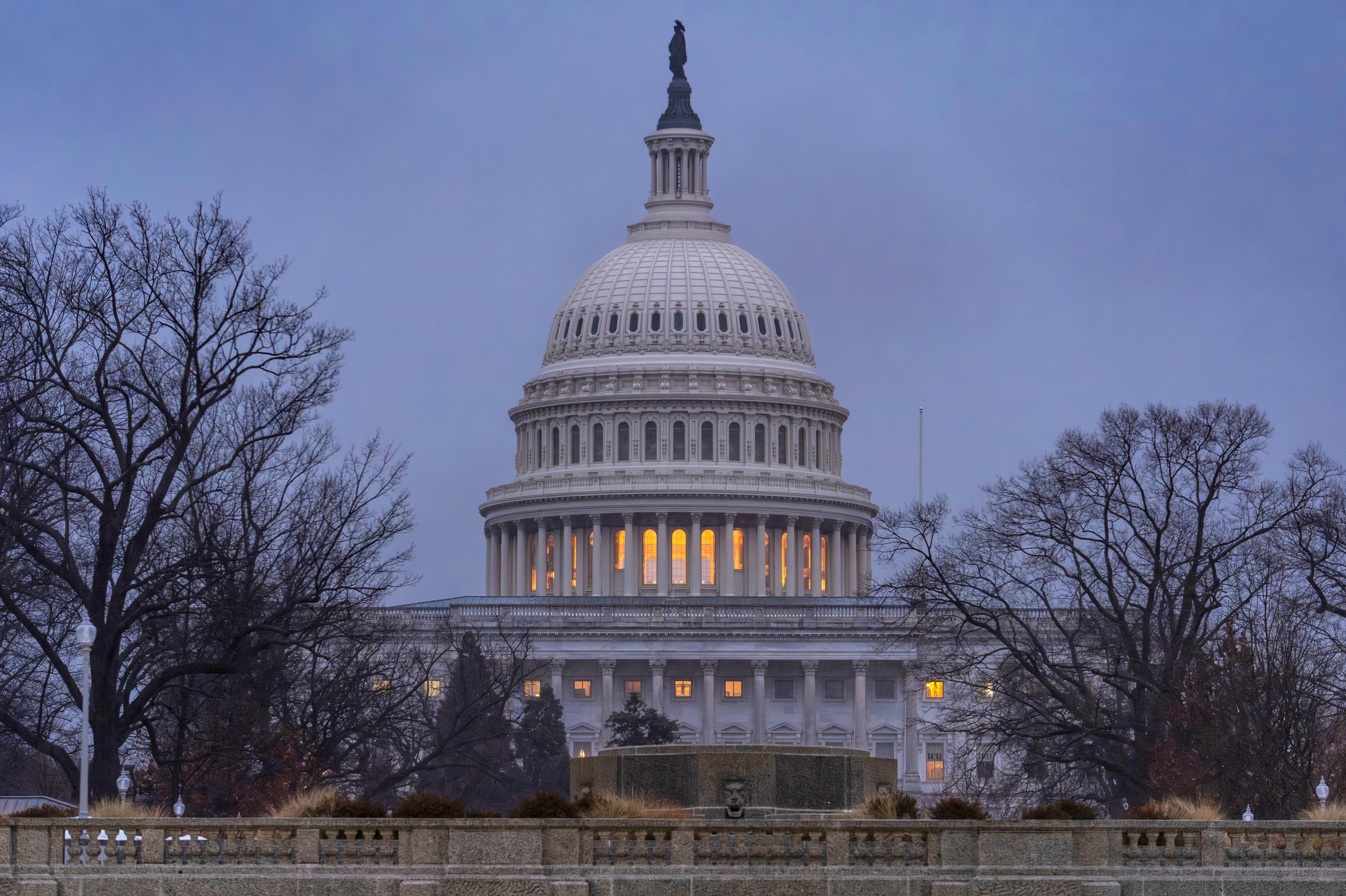 The Capitol is seen during heavy rain as the Department...