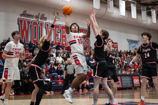 Chaparral High School junior Christian Williams (10) attempts a shot over Fairview defenders during a Class 6A second round playoff game on Friday, Feb. 27, 2026, at Chaparral High School in Parker, Colo. (Photo by Timothy Hurst/The Denver Post)