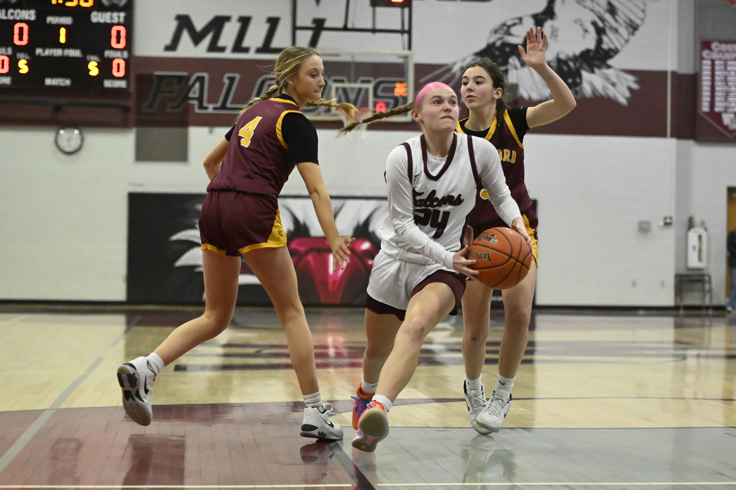 Riley Hollinger splits Herfordâs defense during a playoff basketball game...