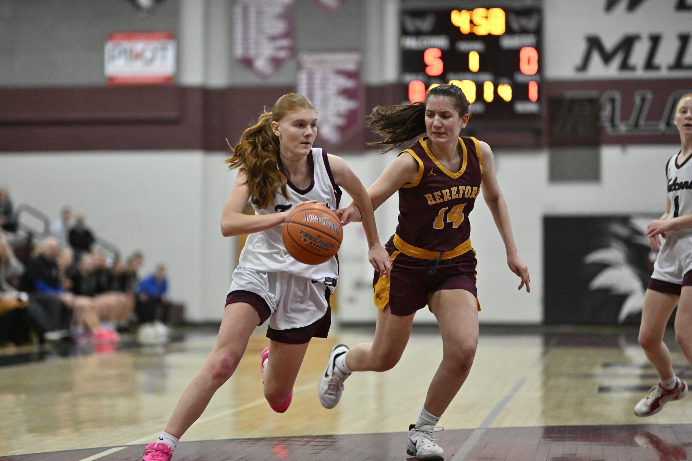 Riley Haskins moves the ball past Herfordâs Hannah Shedahah during...