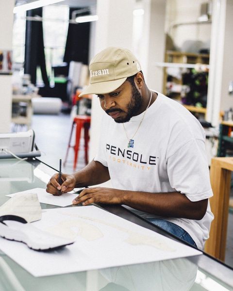 a designer looks at a sneaker