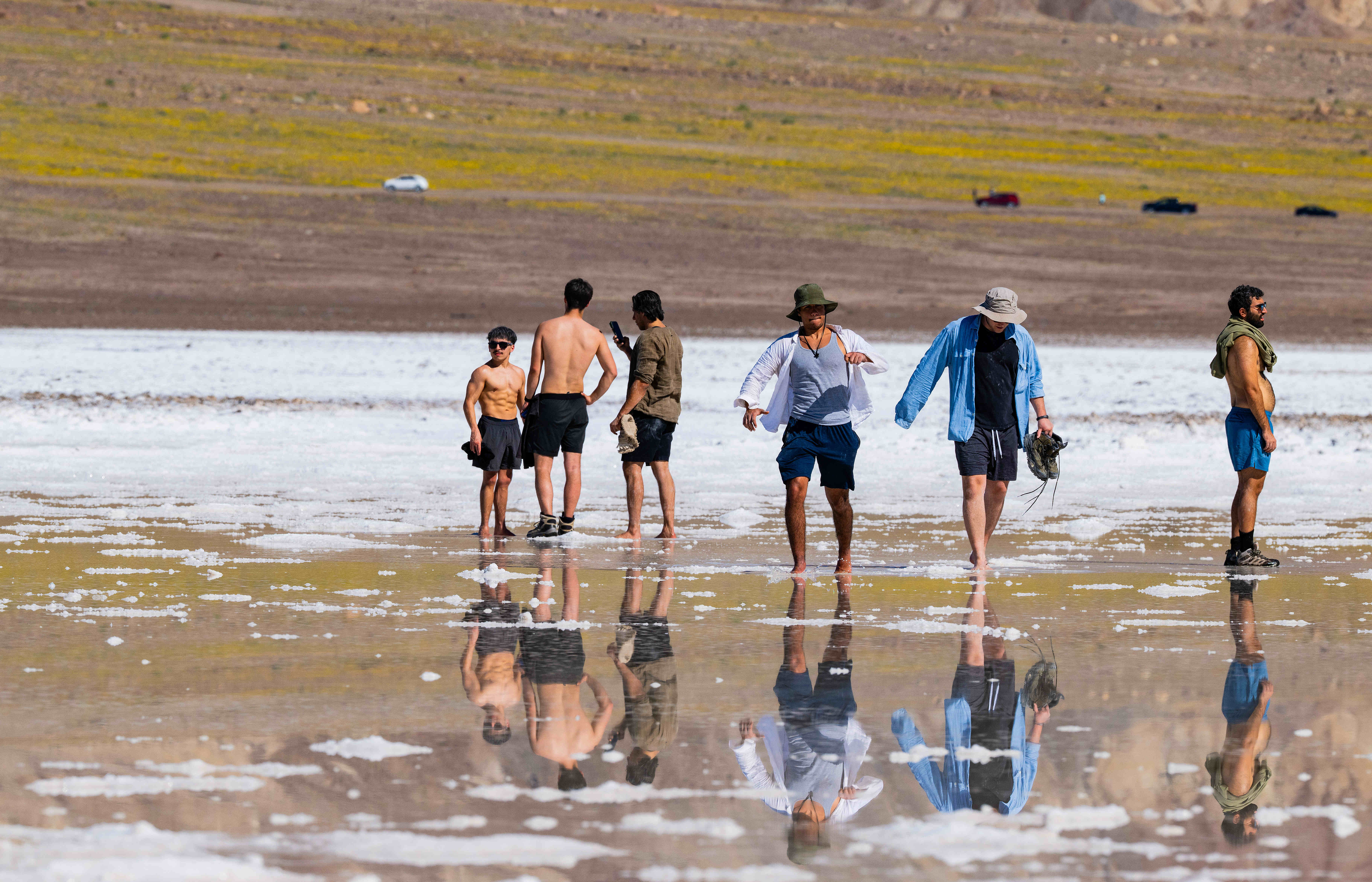 Visitors walk in ankle deep water adjacent to the Devilâs...