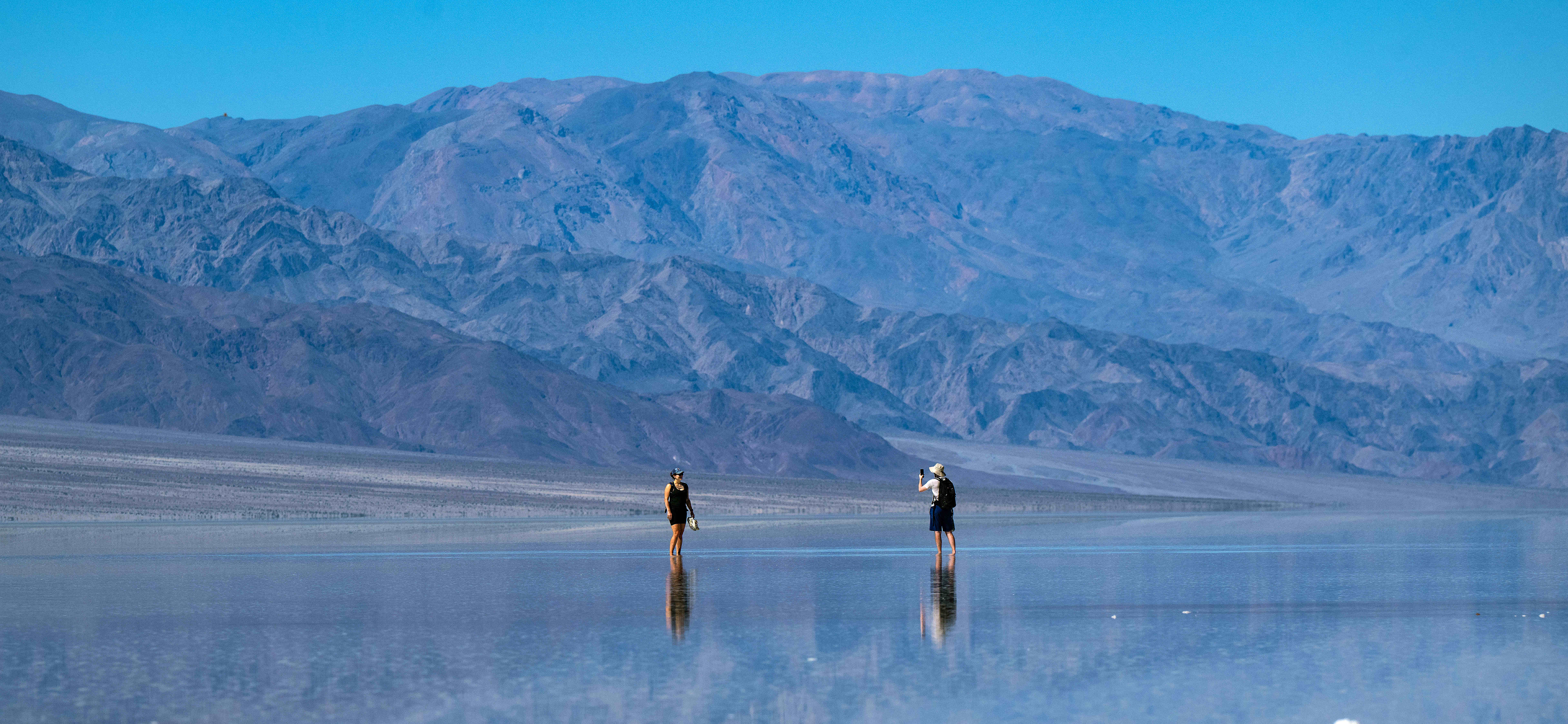 Visitors walk out upon ankle deep Lake Manly located 282...