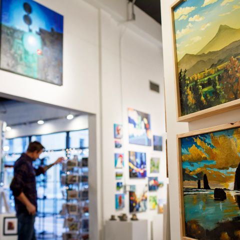 person walking through an art gallery