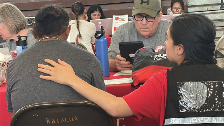 COURTESY CITY AND COUNTY OF HONOLULU
                                Staff assist a resident at the Waialua Community Assistance Center.