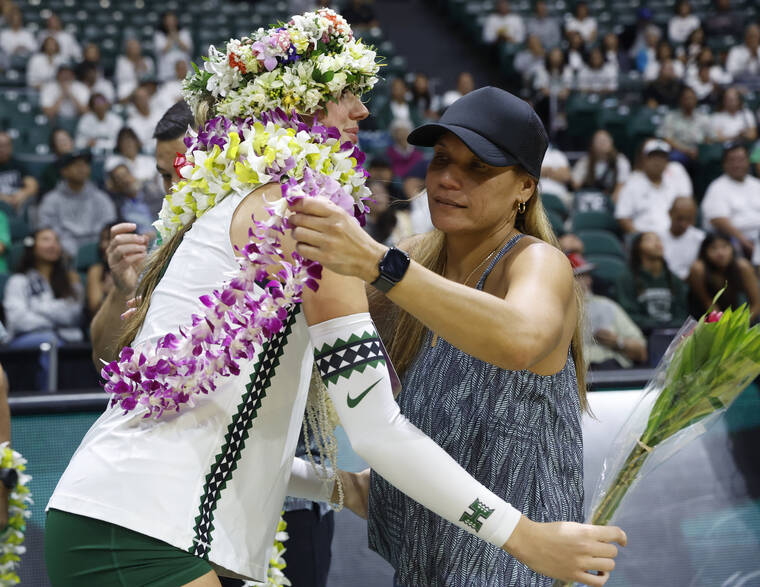 JAMM AQUINO / 2025
                                Hawaii middle blocker Morghn Monahan embraced head coach Robyn Ah Mow during senior night festivities after the final match of the 2025 season at Stan Sheriff Center.