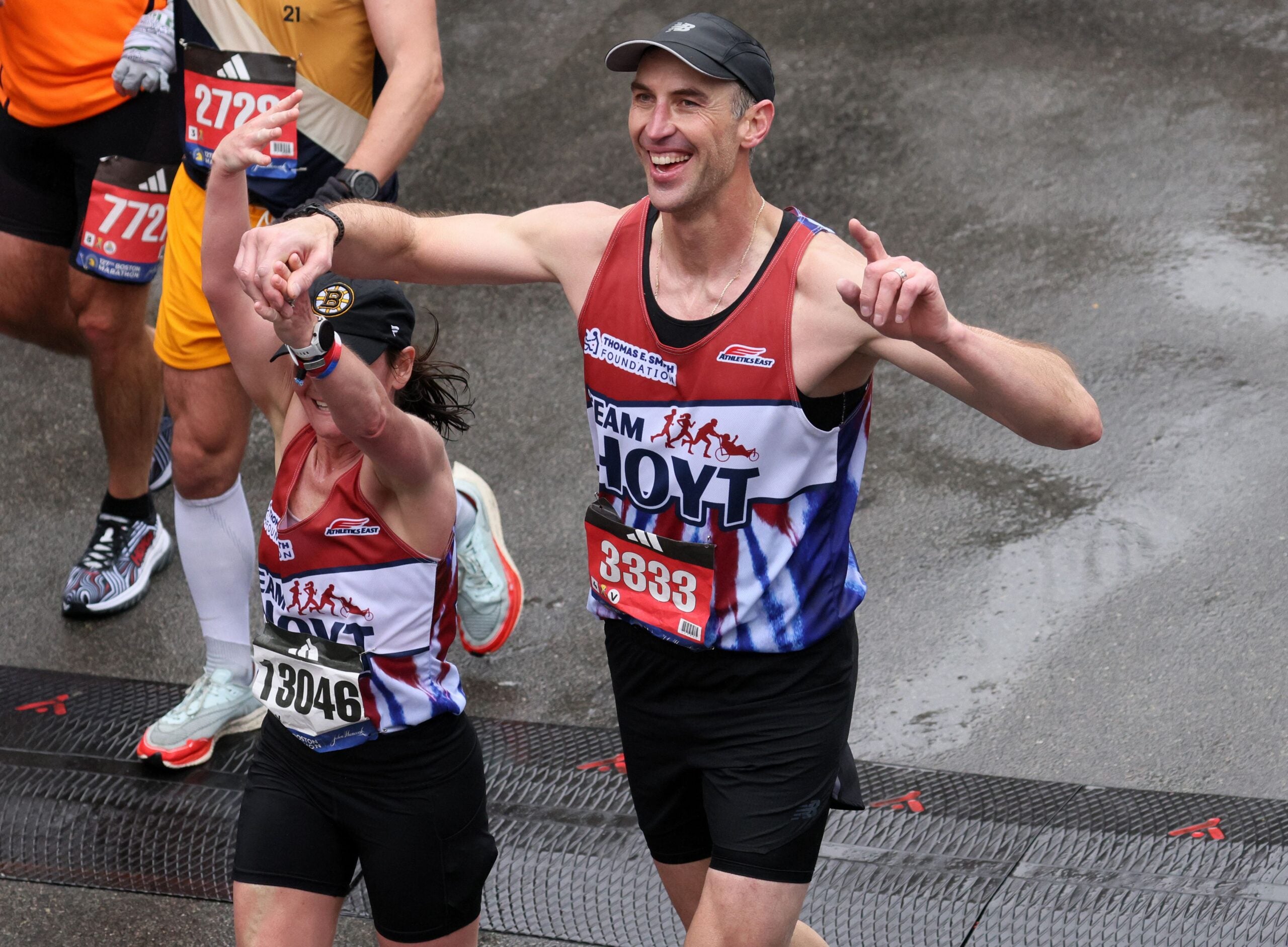 Former Boston Bruins defender Zdeno Chara crosses the finish line at the 2023 Boston Marathon.