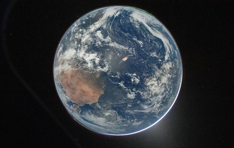 NASA VIA THE NEW YORK TIMES
                                NASA astronaut and Artemis II Commander Reid Wiseman took this picture of Earth from the Orion spacecrafts window on Thursday, after completing the translunar injection burn. NASA has unveiled the first photos of Earth from the spacecraft, the first mission since 1972 to send people around the moon. The land masses visible at left are North Africa and the Iberian Peninsula; at right, the east coast of South America is visible but obscured by clouds.