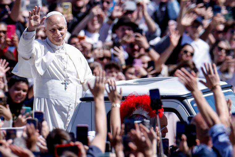 REUTERS/REMO CASILLI
                                Pope Leo XIV waves from the popemobile as he leaves after delivering his Urbi et Orbi (To the city and the world) message, on Easter Sunday, at the Vatican.