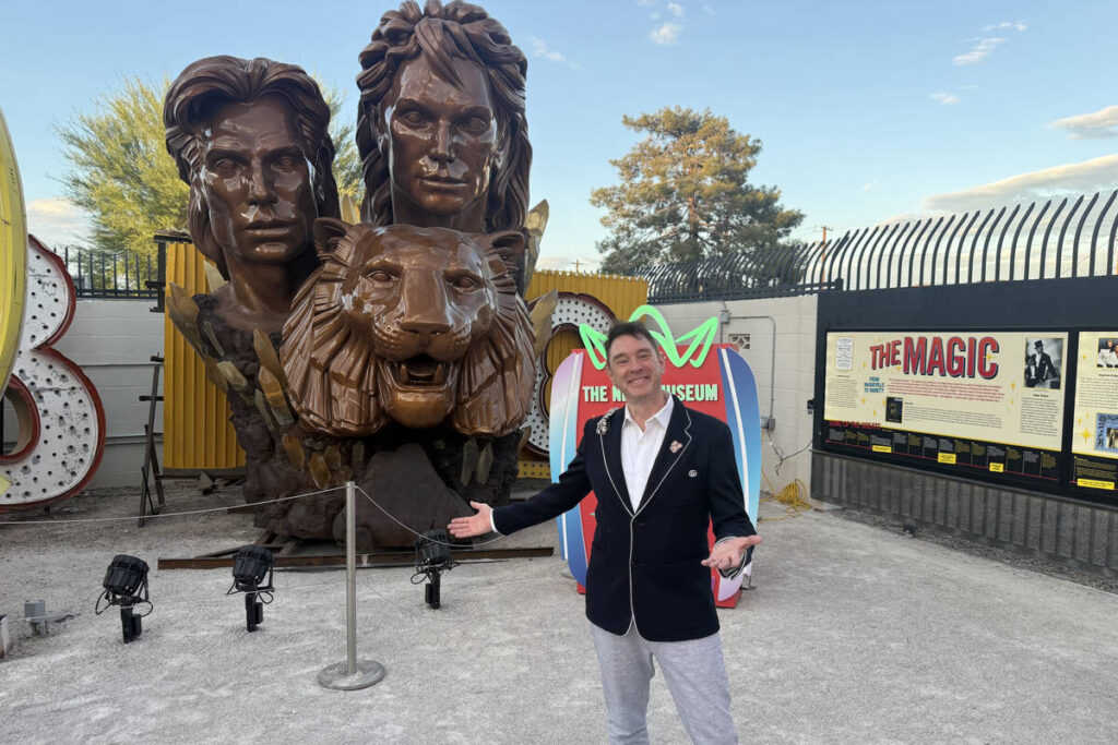 Neon Museum Executive Director Aaron Berger (in blue jacket) is shown at the sculpture of Las V ...
