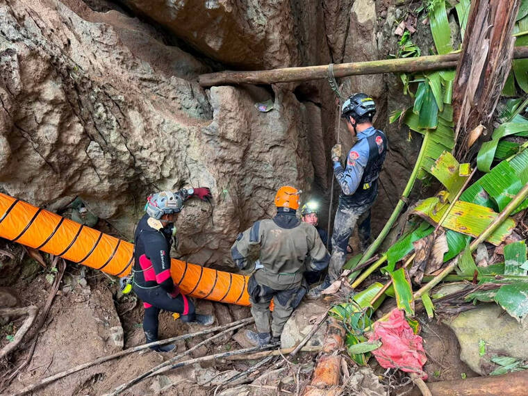 METTA THAM KALASIN RESCUE/HANDOUT VIA REUTERS
                                Members of a rescue team work to save seven people trapped in a cave, at a location given as Xaisomboun Province, Laos, in this handout image released Monday.