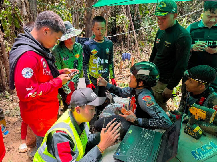 METTA THAM KALASIN RESCUE/HANDOUT VIA REUTERS
                                Members of a rescue team work to save seven people trapped in a cave, at a location given as Xaisomboun Province, Laos, in this handout image released Monday.