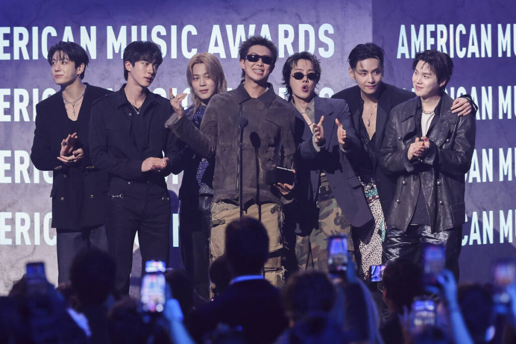 Jungkook, Jin, Jimin, RM, J-Hope, V and Suga of BTS accept the Artist of the Year award onstage ...