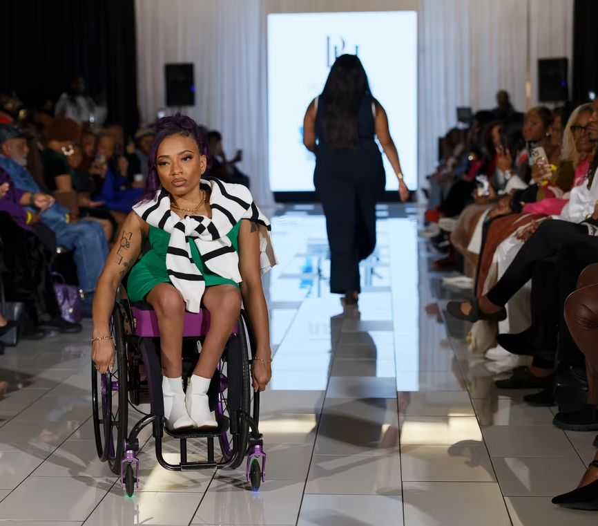 woman in wheelchair modeling on runway