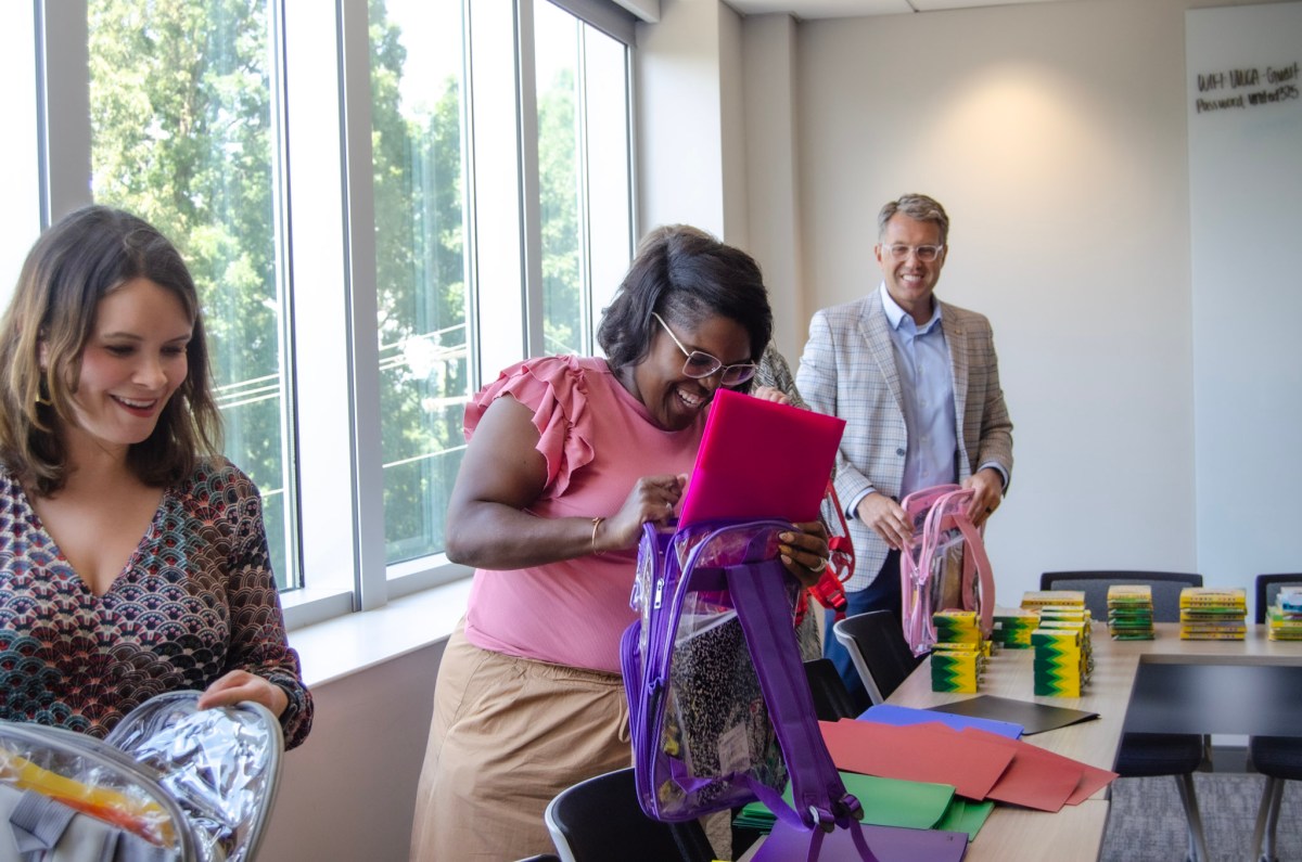 Bham Now team packing back packs with UWCA back-to-school initiatives