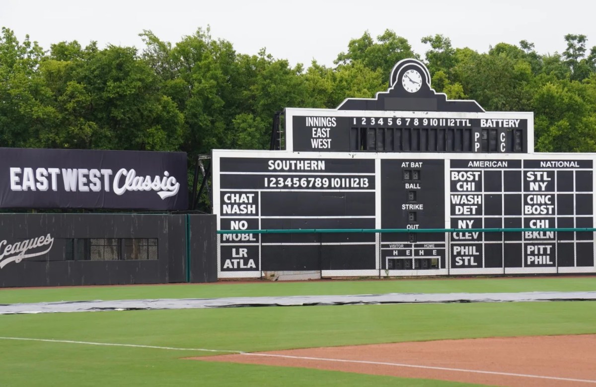 24 weekend events including Juneteenth + Father's Day celebrations (June 19-21) 2 Historic Rickwood Field outfield wall with an East West Classic banner and vintage Negro Leagues scoreboard