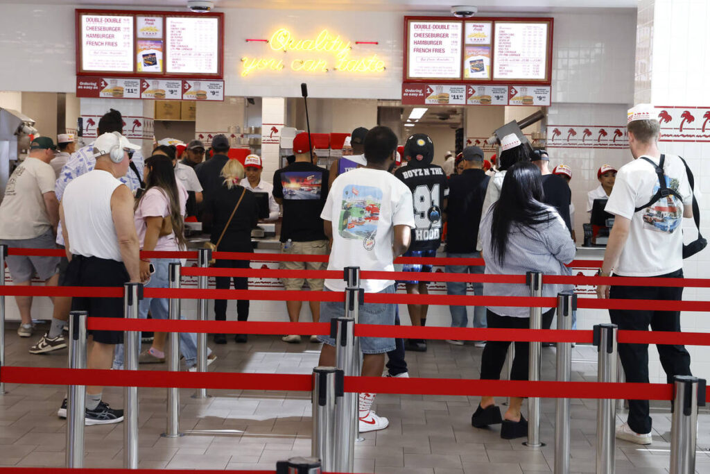 Customers line up to place their orders at a newly opened In-N-Out Burger on Tuesday, June 9, 2 ...