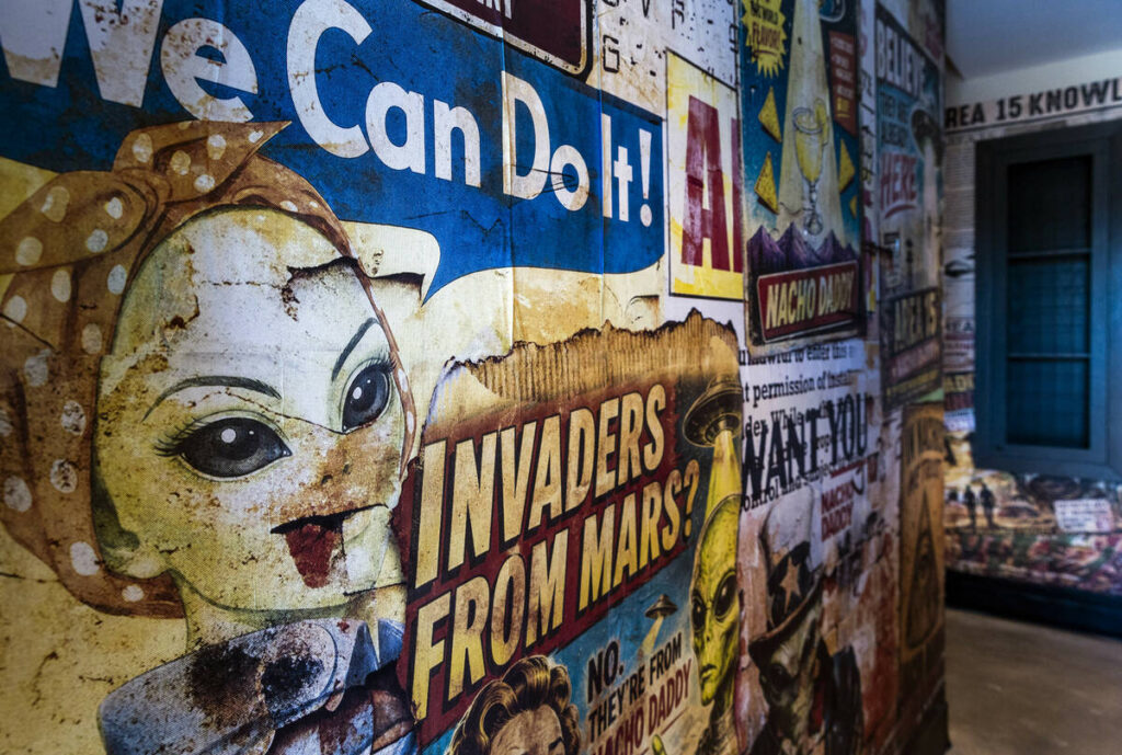 Alien-themed print murals cover the rear hallway at the new Nacho Daddy at Area15 Zone 2 on Tue ...