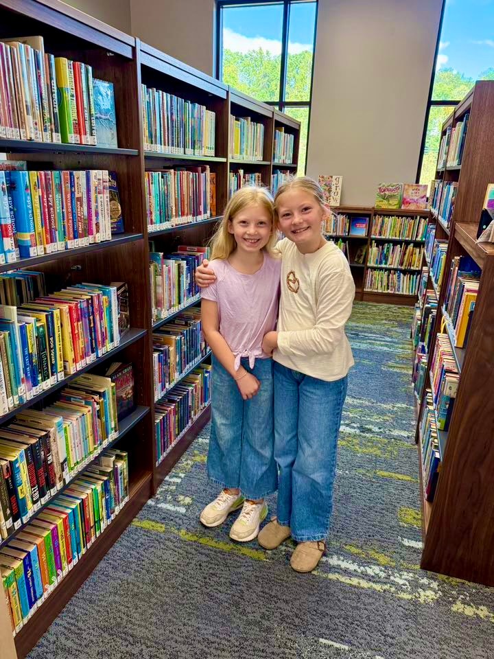 Win big prizes just by reading at Irondale Public Library this summer—it's free + fun 2 Friends and families browsing the shelves at the Irondale Public Library