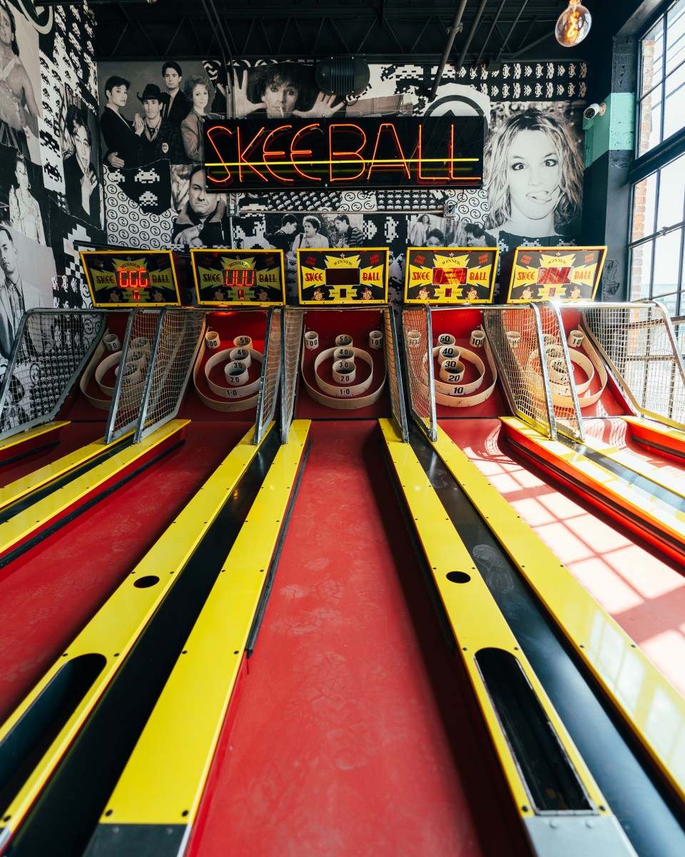Plan now for these 34 weekend events: July 16-19, 2026 5 Skeeball lanes at Up-Down Bar in Birmingham's Southside, with a neon Skeeball sign and pop culture mural on the wall behind them