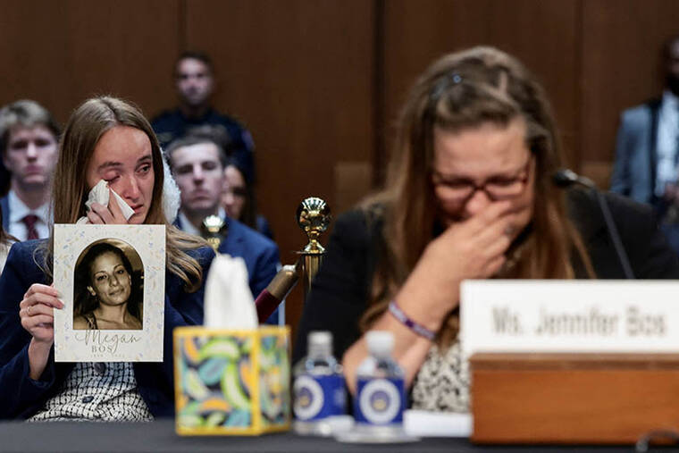 REUTERS/EVELYN HOCKSTEIN
                                Witness Jennifer Bos reacts, as a woman sitting behind her holds a picture of Bos daughter Megan, who was killed by an undocumented immigrant, during the second day of Senate Judiciary Committee confirmation hearings for U.S. Attorney General nominee Todd Blanche on Capitol Hill in Washington, D.C.