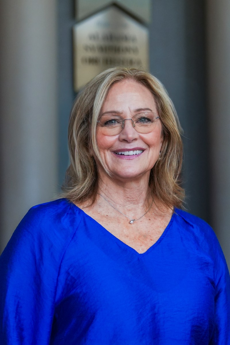 headshot of woman in blue shirt