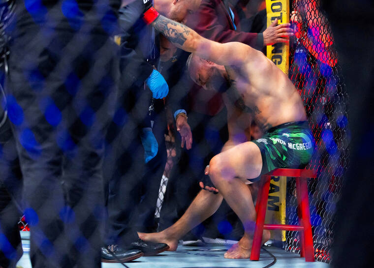 MARK J. REBILAS / IMAGN IMAGES
                                Conor McGregor reacts after suffering an injury that ended his fight with Max Holloway during UFC 329 at T-Mobile Arena.