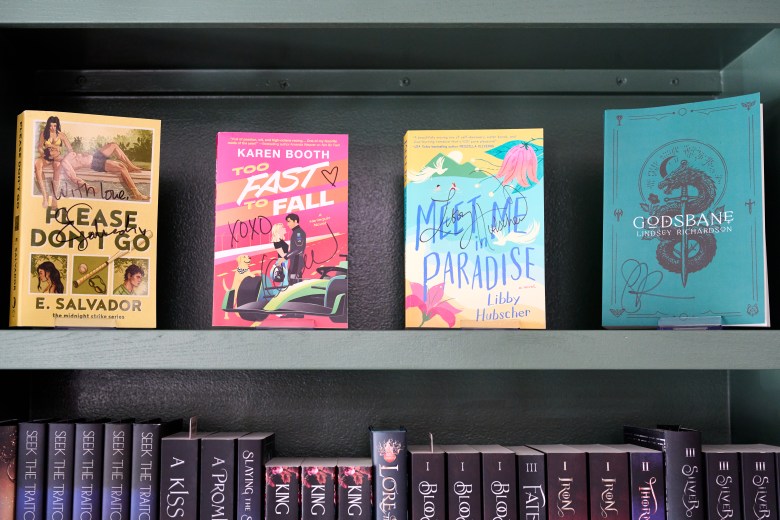 Novels signed by authors who held public signing events adorn the shelves at Bright Side Books & Wine. Photo by Matt Ramey.