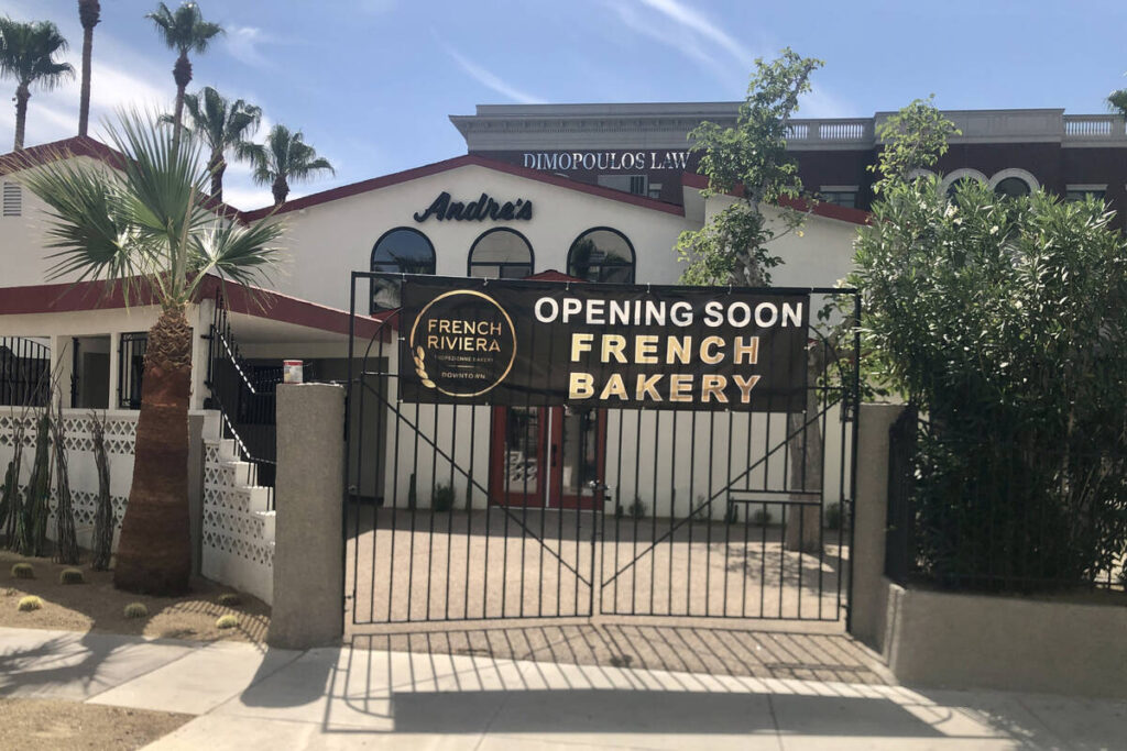 A sign announces that French Riviera Tropézienne Bakery is opening in the former André ...