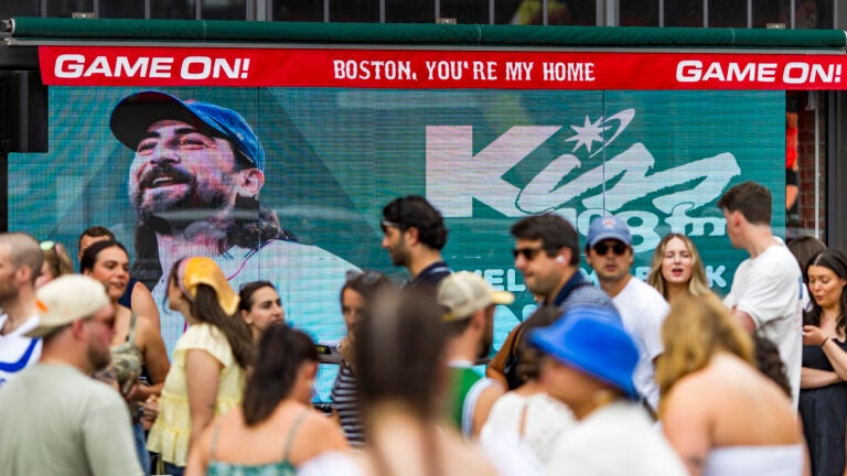 People line up outside before a Noah Kahan concert outside Fenway Park on July 11.
