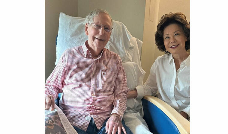 OFFICE OF SENATOR MITCH MCCONNELL/HANDOUT VIA REUTERS
                                U.S. Sen. Mitch McConnell (R-KY) sits with his wife, former United States secretary of labor Elaine Chao, while holding what appears to be the July 12 sports section of the Washington Post in a photograph released by his office in Washington, D.C.