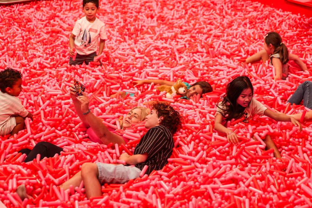 Kids play in the sprinkle pool during an early walkthrough of the Museum of Ice Cream at Area15 ...