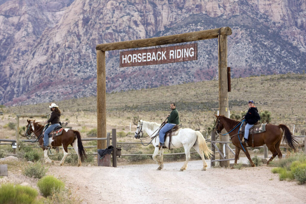 Horseback riders work their way through Red Rock Canyon National Conservation Area near the ent ...