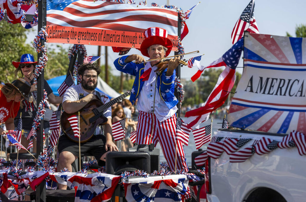 The Americana Man plays for the crowd as his float moves along the route during the 77th Annual ...