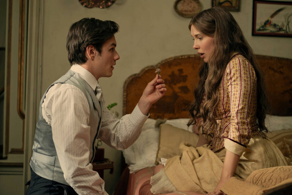This image released by Netflix shows Louis Partridge, left, and Millie Bobby Brown in a scene f ...
