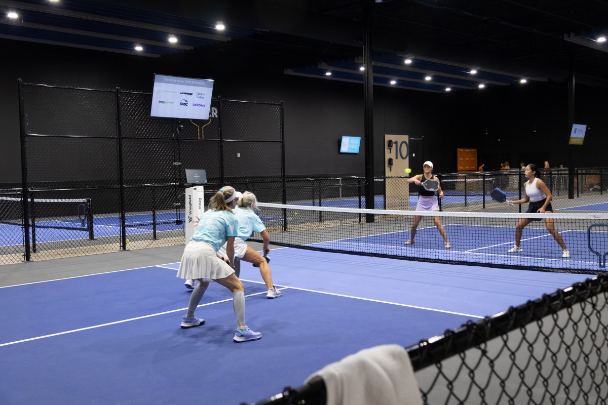 Pickleball for a Purpose 2026: what to know about the Aug. 23 tournament 3 Four women compete in a doubles pickleball match on an indoor blue court during the inaugural 2025 Pickleball for a Purpose tournament in Birmingham