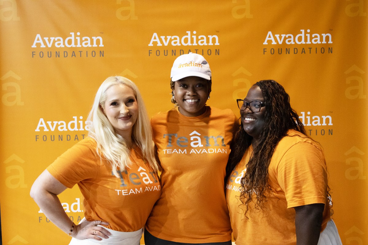 Pickleball for a Purpose 2026: what to know about the Aug. 23 tournament 7 Three Avadian team members in orange Team Avadian shirts smile in front of an Avadian Foundation branded backdrop