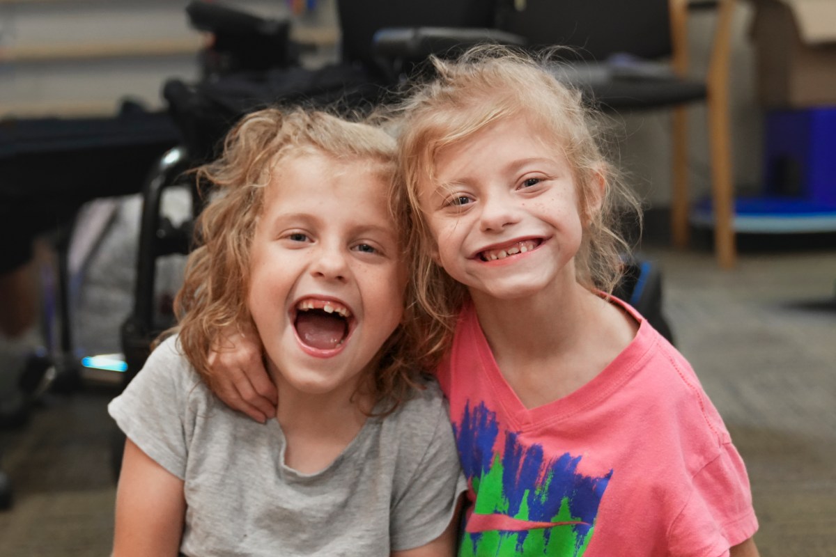 3 reasons you'll love this inclusive circus on August 15—get tickets now 7 Twin sisters with blond hair and big smiles at the camera—United Ability Journey of Hope supports locals with disabilities